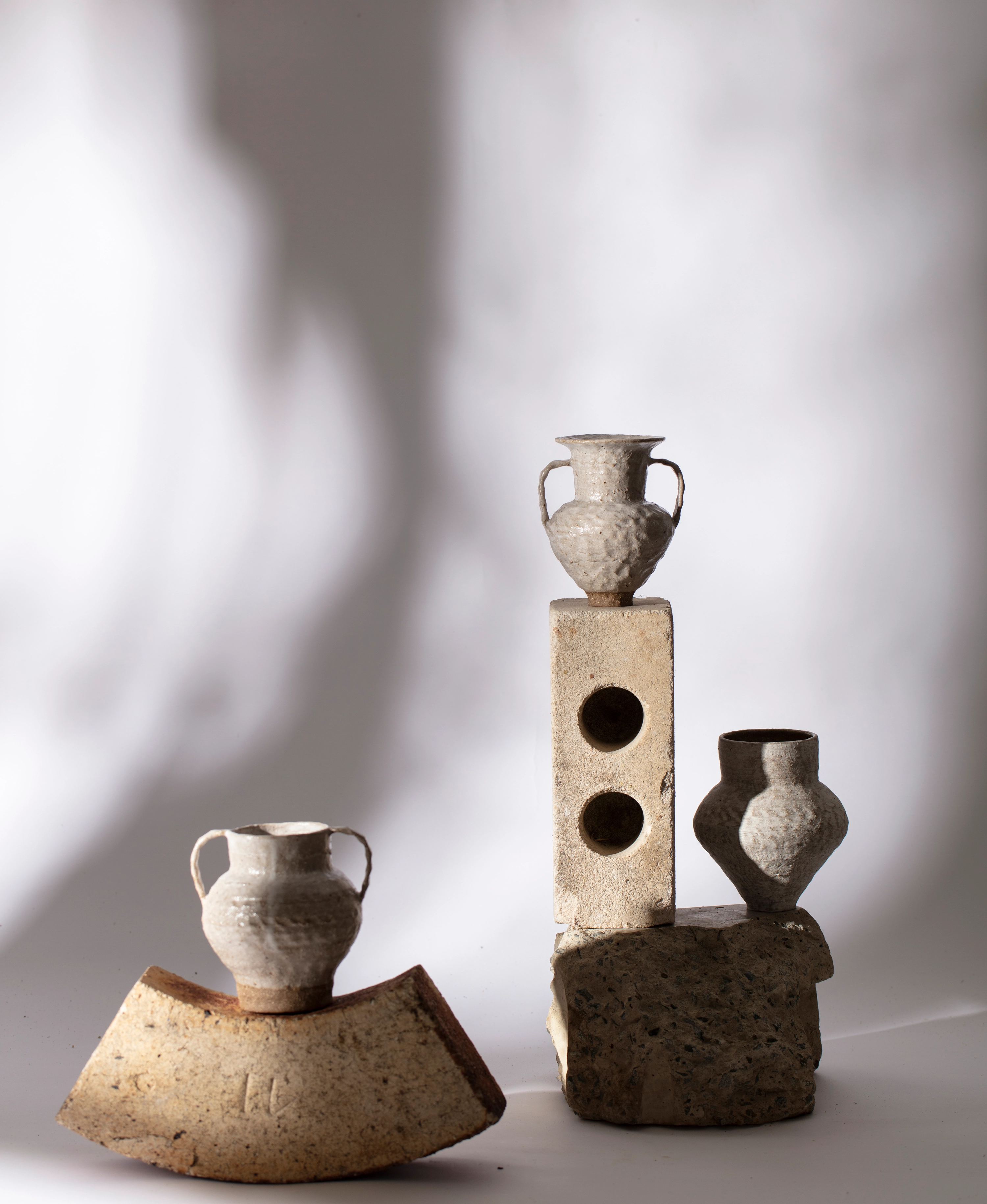 Groundwork #12, 2019. Featuring Joana Partyka, White vase with handles (120x115x112mm), White amphora vase (125x100x98mm), Slip-covered vase (135x110x110mm), glazed dark stoneware.